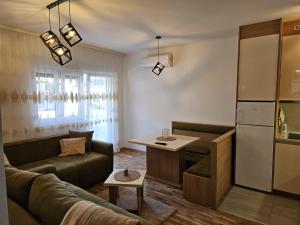a living room with a couch and a table at Apartman Meggy in Belgrade