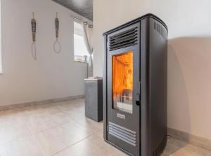 a fireplace is sitting on a floor in a room at Ô Cocoon de Mya in Gedinne