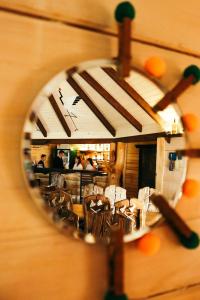 a reflection of a restaurant with tables and chairs at Парк-готель Там, де гори... in Vyzhnytsya