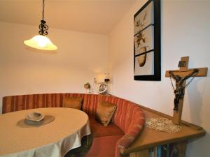 a room with a couch and a table with a hat on it at Apartment Höllwarth by Interhome in Fügenberg