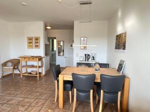 a kitchen and dining room with a wooden table and chairs at Apartment Schwarzwaldblick III by Interhome in Bernau im Schwarzwald