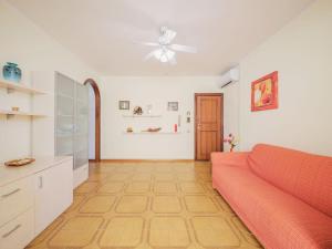 a living room with a couch and a ceiling fan at Apartment Dei Fiori by Interhome in Lido di Camaiore