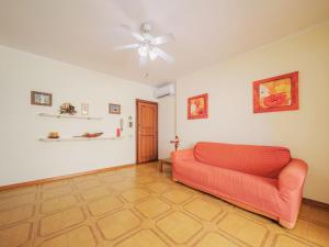 a living room with a couch and a ceiling fan at Apartment Dei Fiori by Interhome in Lido di Camaiore