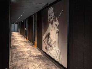 a hallway with a picture of a woman on a wall at ibis Styles Fontenay in Fontenay-sous-Bois