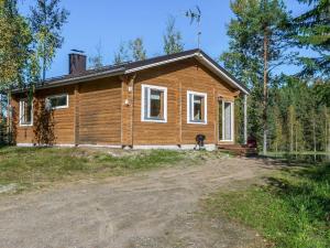 a small wooden house in the woods at Holiday Home Koskenniska by Interhome in Kortteinen