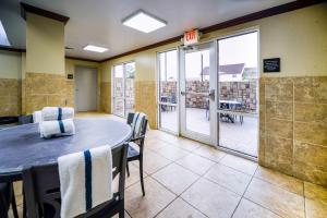 a room with a table and chairs and a balcony at Hampton Inn Bryant in Bryant