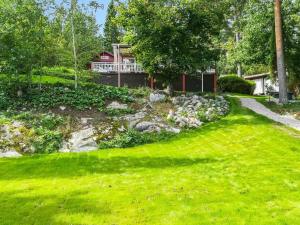 a yard with green grass and a house at Holiday Home Lomaranta by Interhome in Paksalo