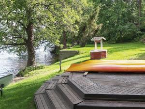 a large surfboard sitting on a table next to a body of water at Holiday Home Lomaranta by Interhome in Paksalo