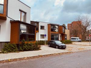 a car parked in a parking lot next to buildings at Appartament Karja 26A/10 in Narva-Jõesuu