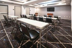 a conference room with tables and chairs and a screen at Hampton Inn Bryant in Bryant