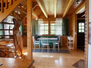 a dining room with a table and chairs in a cabin at Holiday Home Ranta-lemettilä by Interhome in Petäjävesi