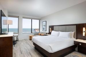 a hotel room with a bed and a view of the ocean at Hilton Galveston Island Resort in Galveston