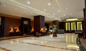 a lobby of a hotel with tables and chairs at Best Western Mangga Dua Hotel & Residence in Jakarta