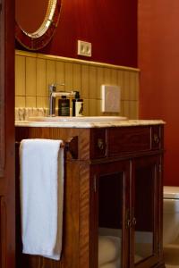 a bathroom with a sink and a towel on a counter at La Novieta Boutique Hotel - Adults Only in Valencia