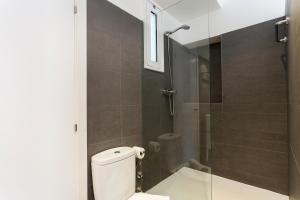 a bathroom with a toilet and a glass shower at AB Paral-lel Tapioles in Barcelona +11 photos