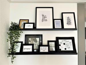 a shelf with framed pictures on a wall at Holiday Home Brouwershaven by Interhome in Brouwershaven