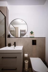 a bathroom with a sink and a mirror at Mountain View with Terrace in Sinaia +70 photos