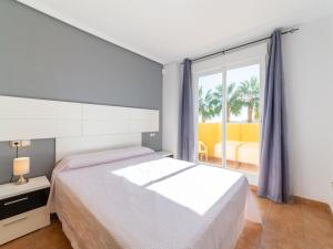 a bedroom with a bed and a large window at Apartment Lomas del Mar V-2 by Interhome in Playas de Vera