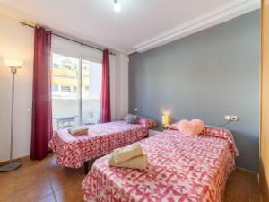 a bedroom with two beds and a window at Apartment Lomas del Mar V-2 by Interhome in Playas de Vera