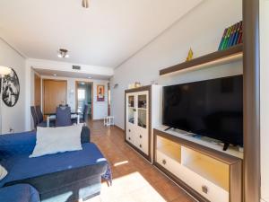 a living room with a large flat screen tv at Apartment Lomas del Mar V-2 by Interhome in Playas de Vera