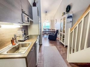 a kitchen with a sink and a dining room at Holiday Home Skivillas 61 ukkohalla - b1 by Interhome in Hyrynsalmi