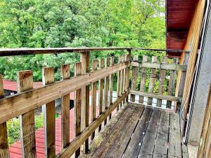 a wooden deck with a view of the woods at Cosy au calme, climatisation, 3min A41 in Bernin
