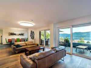 a living room with a couch and a table at Apartment Grosse Freiheit alpe maritima Ski&See-17 by Interhome in Annenheim