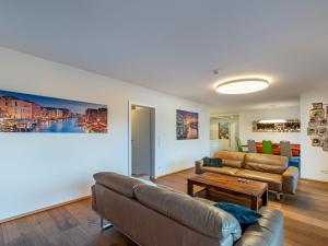 a living room with two couches and a table at Apartment Grosse Freiheit alpe maritima Ski&See-17 by Interhome in Annenheim