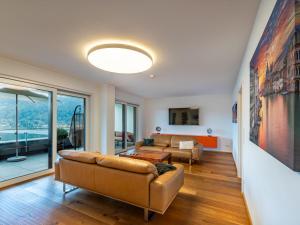 a living room with a couch and a table at Apartment Grosse Freiheit alpe maritima Ski&See-17 by Interhome in Annenheim +32 photos