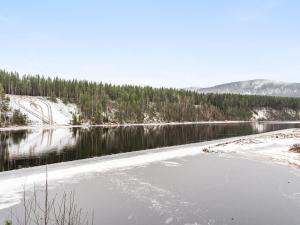 a body of water with snow on the shore at Chalet Norrskensstugan - NBO010 by Interhome in Vidsel