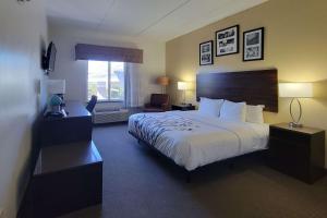 a hotel room with a large bed and a window at Sleep Inn & Suites Panama City Beach in Panama City Beach