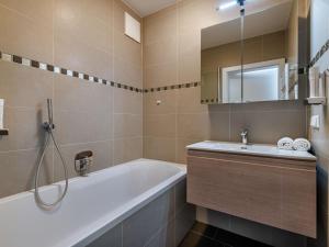 a bathroom with a tub and a sink at Apartment Terrassentraum alpe maritima Ski&See-15 by Interhome in Annenheim