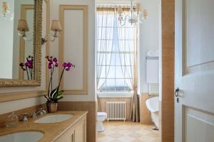 a bathroom with a sink and a toilet and a mirror at Tivoli Palácio de Seteais Sintra Hotel - The Leading Hotels of the World in Sintra