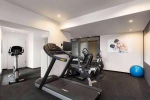a gym with two tread machines and a treadmill at Vienna House Easy by Wyndham Bucharest Airport in Otopeni +124 photos