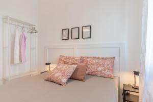 a bedroom with a bed with a pillow and clothes racks at Casa Olimpo vicino alle spiagge di sabbia in Specchiolla 