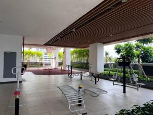 a gym with two treadmills and chairs in a building at R&F Princess Cove@2Bed2Bath in Johor Bahru