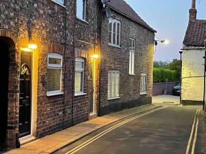 an empty street next to a brick building at No. 3 A cosy spot for 4 in Cawood