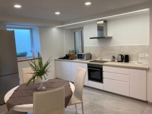 a kitchen with a table and chairs in a kitchen at Appartamento Casa Roby in Montecatini Terme