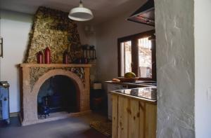 a kitchen with a fireplace in the middle of a room at Los Diezmos in Torremocha de Jarama