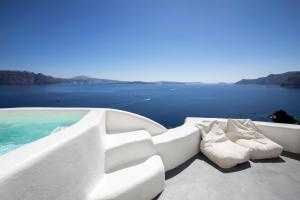 a boat with two pairs of shoes sitting on the deck at Ducato Di Oia in Oia