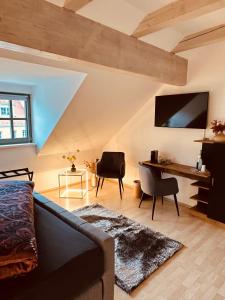 a living room with a couch and a desk at Apartment Altstadt Freiberg in Freiberg