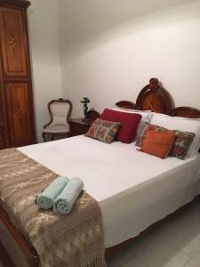 een slaapkamer met een groot bed en handdoeken bij RENT ROOM JOE Via Dante 77 Solarino in Solarino