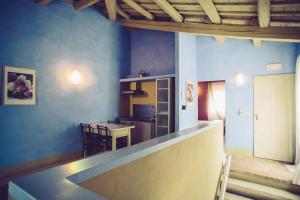 a kitchen with blue walls and a counter top at Turchi Farm - Locanda della Luna & Antico Frantoio in Longiano