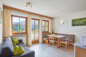 a living room with a couch and a table at Ratschingser Kreuz Blasighof in Racines