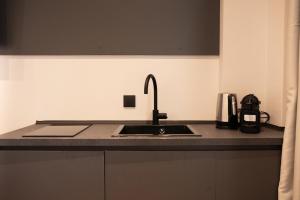 a kitchen with a sink and a counter top at Taskou Luxury Suites in Thessaloniki
