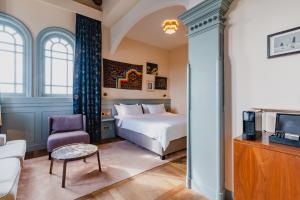 a hotel room with a bed and a tv at Hotel Mercier in Amsterdam