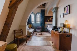 a living room with an archway and a room with a couch at Hotel Mercier in Amsterdam