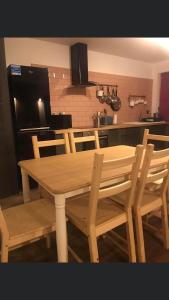 a wooden table and chairs in a kitchen at Kilcloon Holiday Homes & Private Rooms in Maynooth