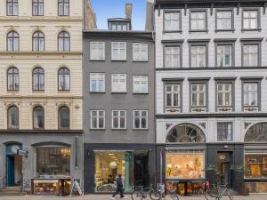 a group of buildings on a street with a store at Sanders Main - Popular Two-Bedroom Duplex Apartment Next to Magical Nyhavn in Copenhagen