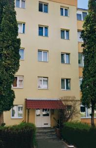 a large building with a garage in front of it at Vlad Apartament in Braşov